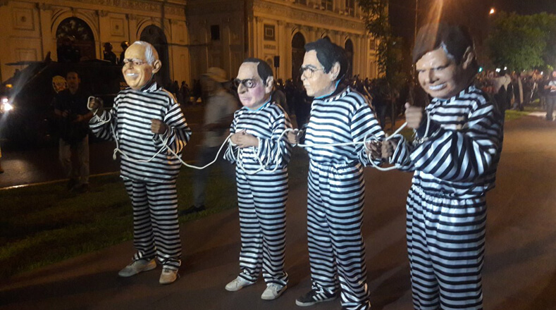 Durante la manifestación, ciudadanos usaron máscaras que representaban a autoridades peruanas mientras usaban uniformes de reos. Uno de ellos fue el jefe de Estado peruano.