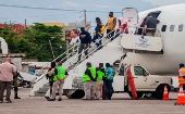 Migrantes haitianos deportados desde EE.UU. se bajan de un avión en el aeropuerto Toussaint Louverture en Puerto Príncipe.